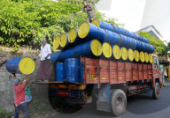 Workers Load Empty Barrels