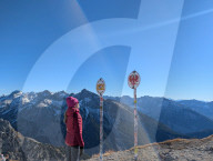 Hikers At The Border Signs For Bavaria And Tyrol In The Karwendel Alps