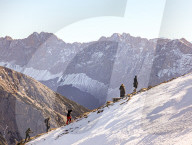 Group Ascending Snowy Mountain