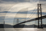 Daily Life Along Lisbon’s Riverside As Locals Fish Beneath The 25 De Abril Bridge