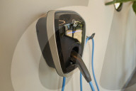  Driver's Hands On Steering Wheel In An Electric BMW