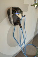  Driver's Hands On Steering Wheel In An Electric BMW