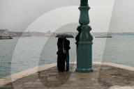 Couple Kisses Under Umbrella In Rain