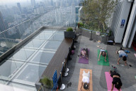 Practicing Yoga On The Rooftop Of Indonesia's Tallest Building.
