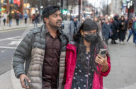 Travellers wear masks at London Victoria Station. 