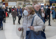 Travellers wear masks at London Victoria Station. 