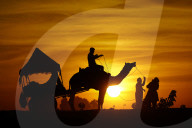 Tourists Enjoy a Camel Safari - India