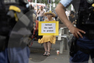 People hold posters opposing Israel's genocide at a pro-Palestinian rally in the front of the Sydney Town Hall.