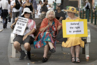 People hold posters opposing Israel's genocide at a pro-Palestinian rally in the front of the Sydney Town Hall.