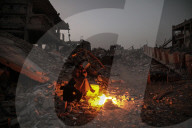 Gazans in tents resort to rubble fires for warmth