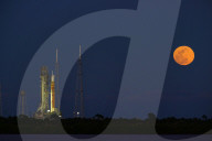 Snow Moon Rises Behind NASA Artemis II Rocket